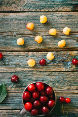 Ahşap bir arka planda taze ev yapımı olgun kirazlar. Yaz hala hayat