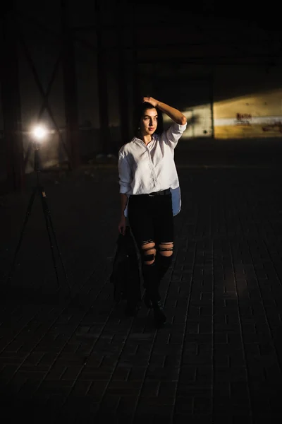 Girl in a leather jacket on an old abandoned construction site — Stock Photo, Image