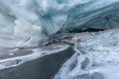 Soğuk dağ nehrinin güneşli kış günündeki manzarası. 