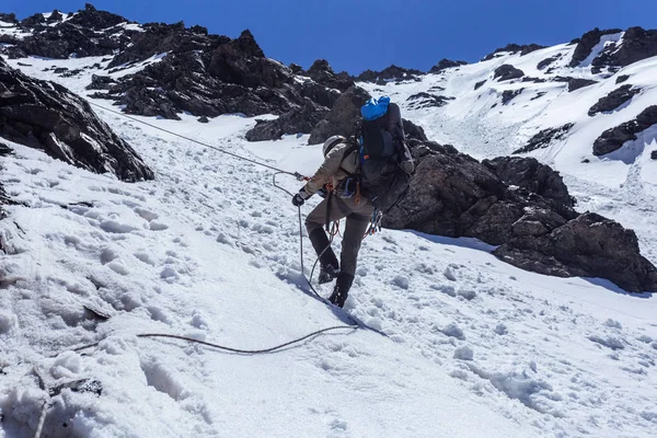 Male hiker in warm sporty clothes hiking in mountains