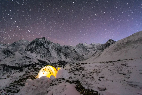 night sky over Belukha Mountain. Tent in the snow in the winter on the mountain elephants