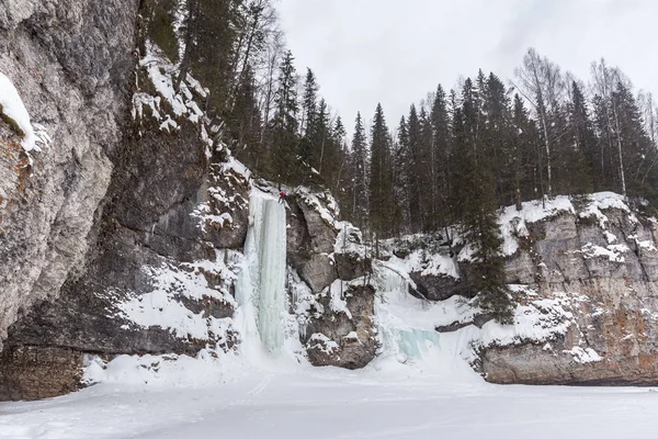 frozen flow in snowy mountains at winter day, Urals