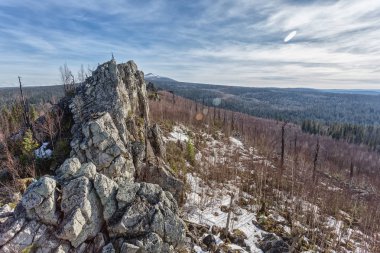 picturesque view of endless coniferous forest and rocks  at sunny day, Yerani village, Urals clipart