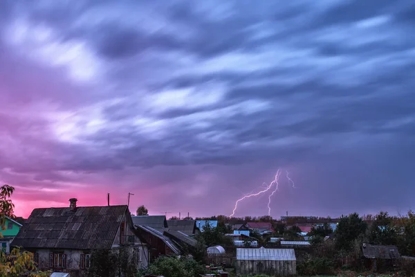 lightning above the city at sunset. thunderstorm with lightning