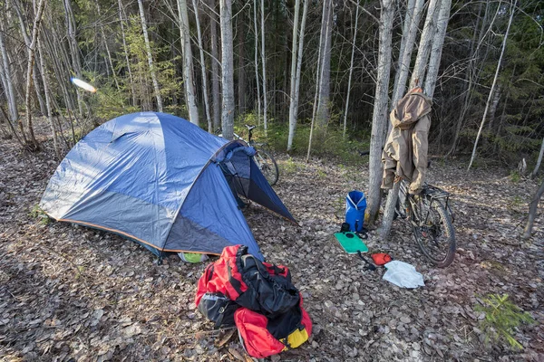 Bike trip, bike trip to the forest. A tent stands in the woods,