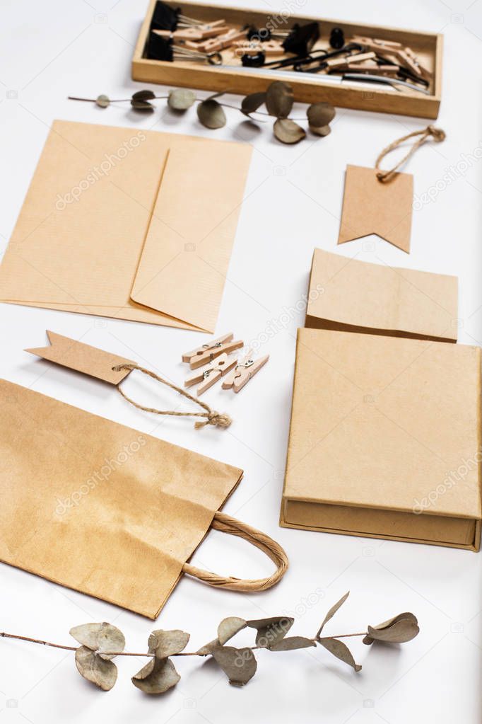 Envelop, bag, label, papaer and other stuff on a white desk