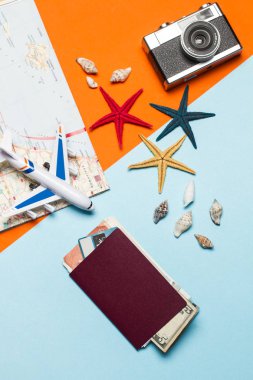 Bir oyuncak uçak ve turuncu ve açık mavi arka plan üzerinde seyahat şeyler