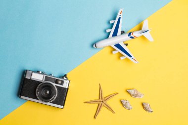 Sarı ve açık mavi arka plan üzerinde kamera ile bir oyuncak uçak