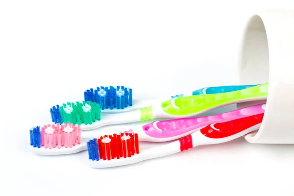 Four Plastic Toothbrushes Ceramic Glass White Background — Stock Photo, Image