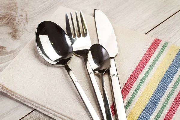 Cutlery on a white and stripped napkin