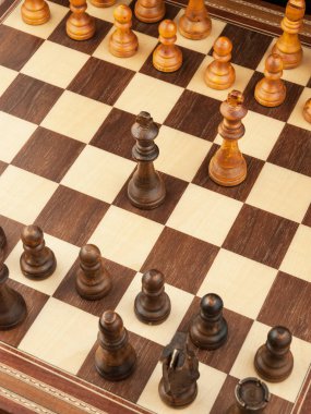 Karanlık bir arka plan üzerinde tahta ve satranç taşları