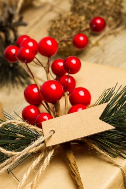 Ahşap bir masa üzerinde holly ile Noel paketleri