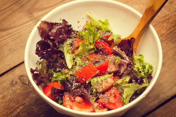 Tomatoes and lettuce salad with quinoa seeds