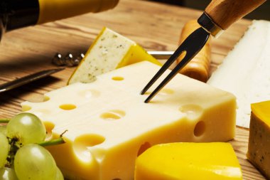 Ahşap bir masada peynir ve üzüm meze