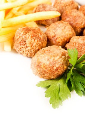 Kroket ve maydanoz yaprakları beyaz tabakta