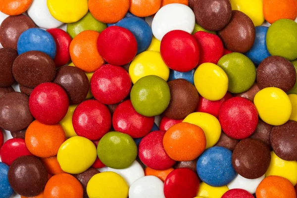 Multicolored hard shell chocolate candies in a top view