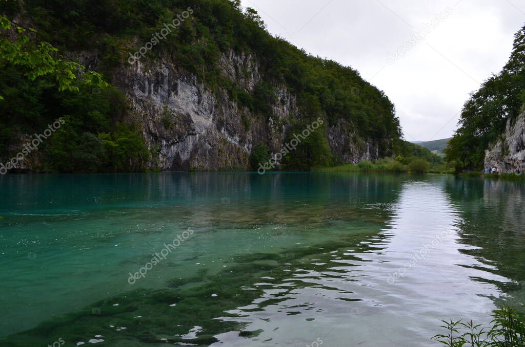 Turquoise surface of the lake among rocks