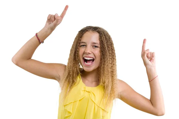 Ευτυχισμένος ξανθιά με σγουρά μαλλιά, κορίτσι έφηβος δείχνει το δείκτη επάνω, υποδεικνύοντας αντίγραφο χώρου στο λευκό κενό τοίχο για το περιεχόμενο ή τις πληροφορίες, απομονωμένο — Φωτογραφία Αρχείου