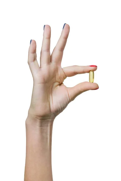 Primo piano della capsula vitamina D, E, A olio di pesce omega-3 in mano femminile, su sfondo bianco isolato — Foto Stock