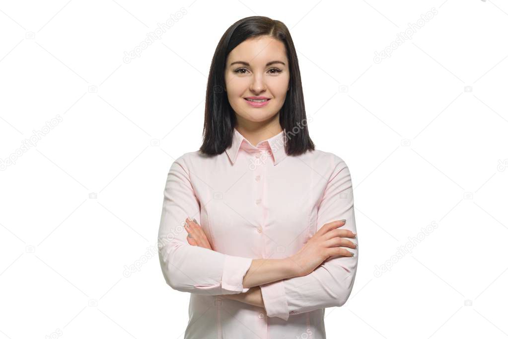 Confident young business woman with crossed arms in pink shirt on white isolated background