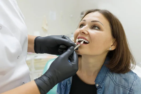 Adult woman sitting in chair of dentist in clinic and preparing for procedure. Medicine, dentistry and healthcare concept. — Stock Photo, Image