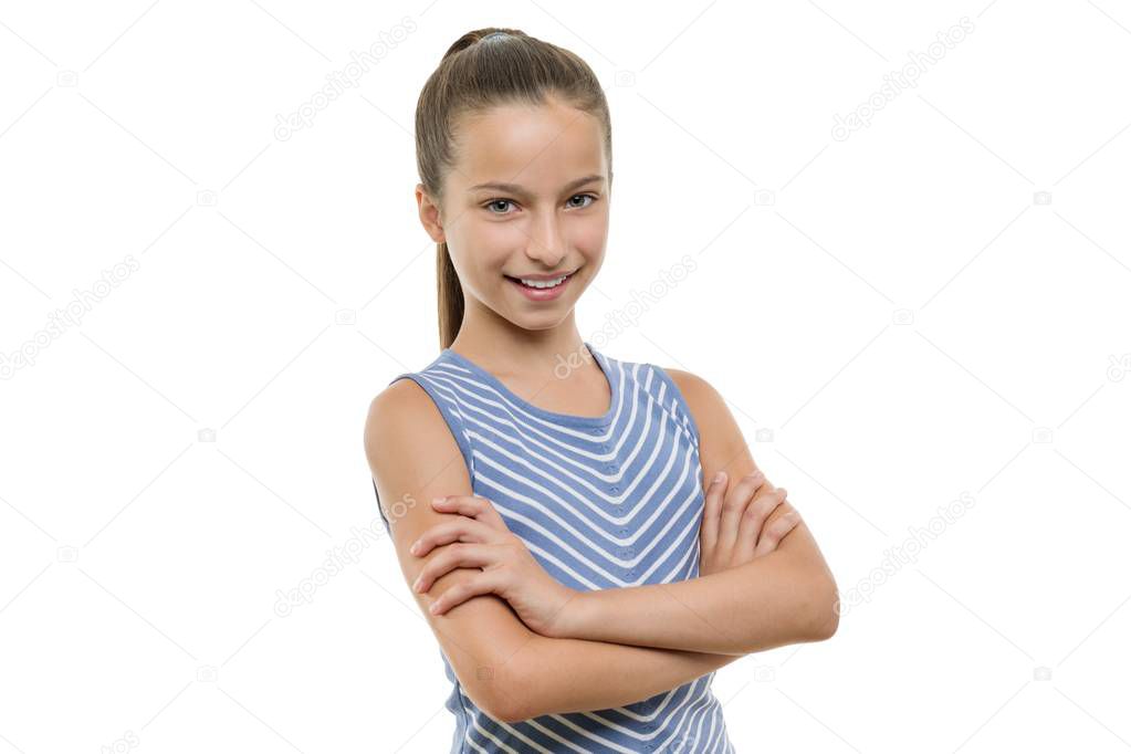 Portrait of confident beautiful young smiling girl with arms crossed. Child with perfect white smile, isolated on white background