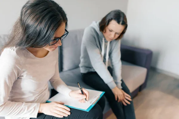 Teenager patient girl talking with professional psychotherapist in office. — Stock Photo, Image