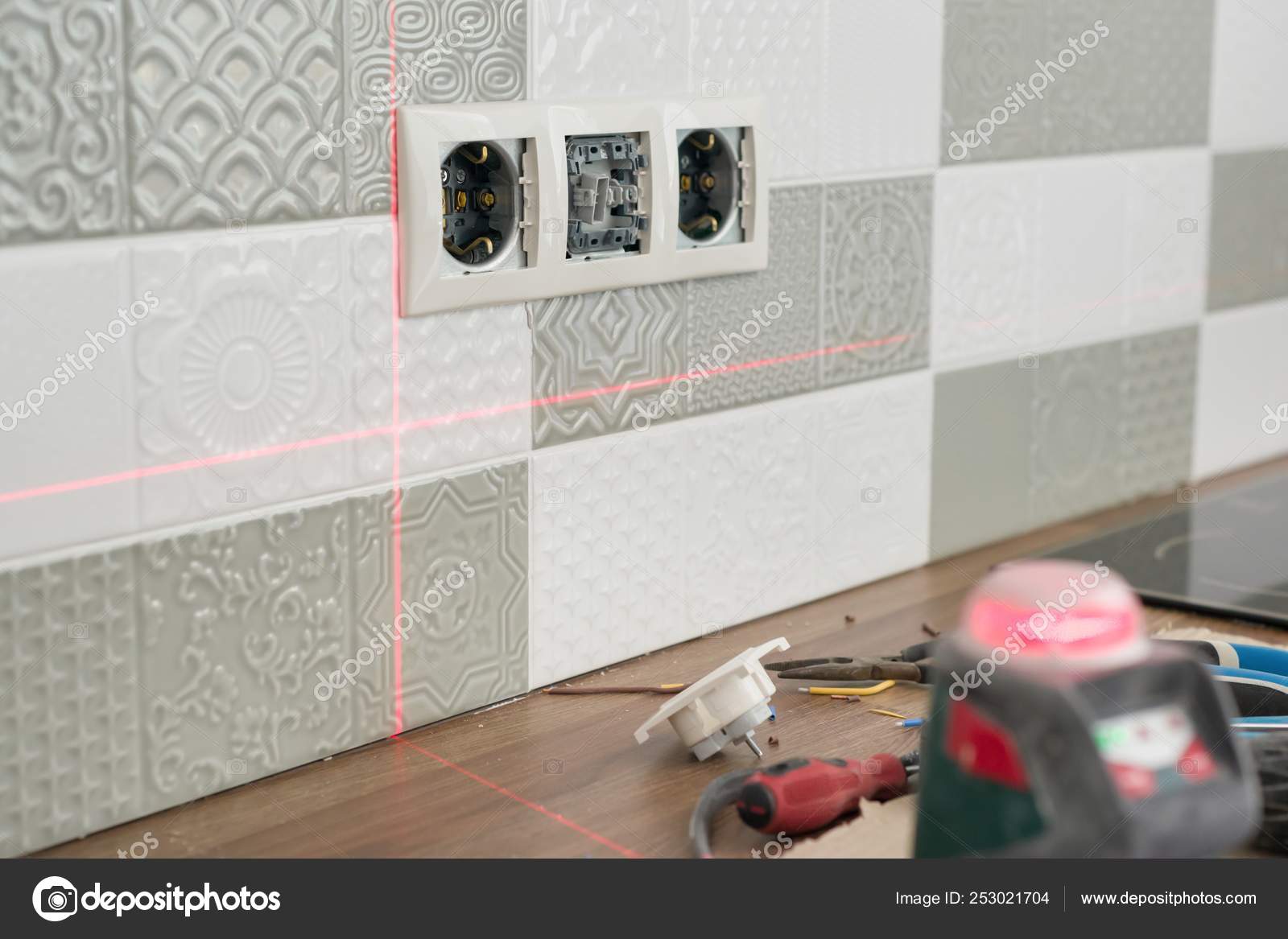 Electrician Using Infrared Laser Level To Install Electrical