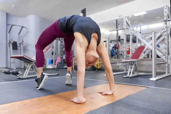 Ενηλίκων σπορ ξανθιά γυναίκα, τεντώνοντας το σώμα ενώ κάνει γιόγκα ασκήσεις στο γυμναστήριο — Φωτογραφία Αρχείου