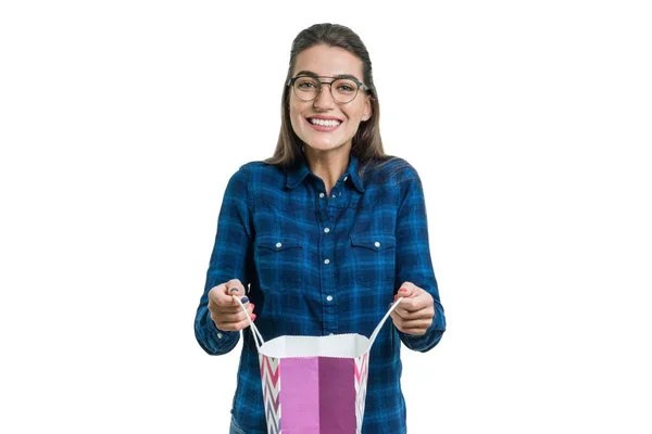 Happy young woman with a shopping bag, isolated on white background, caucasian female with glasses and casual shirt — Stock Photo, Image