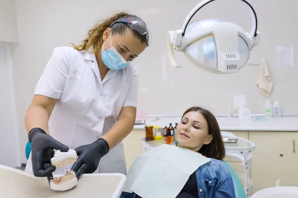 Adult female dentist treating patient woman teeth. Medicine, dentistry and healthcare concept — Stock Photo, Image