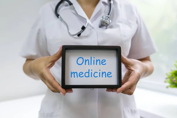 Medicine online text in the hands of a female doctor