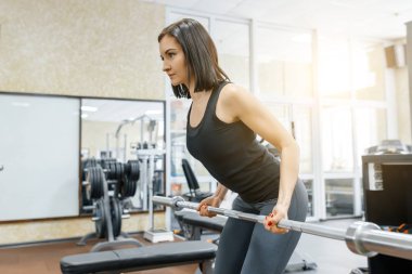 Genç güzel atletik kadın esmer spor salonunda Fitness egzersizleri yapıyor. Fitness, spor, eğitim, insanlar, sağlıklı yaşam konsepti.