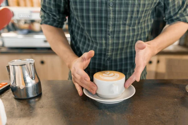 Hands barista fresh coffee art in a white cup np gray stone tabletop — Stock Photo, Image