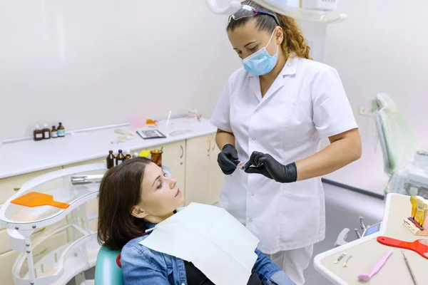 Partial denture, mature woman patient sitting in dental chair, doctor dentist doing dental prosthesis. — Stock Photo, Image