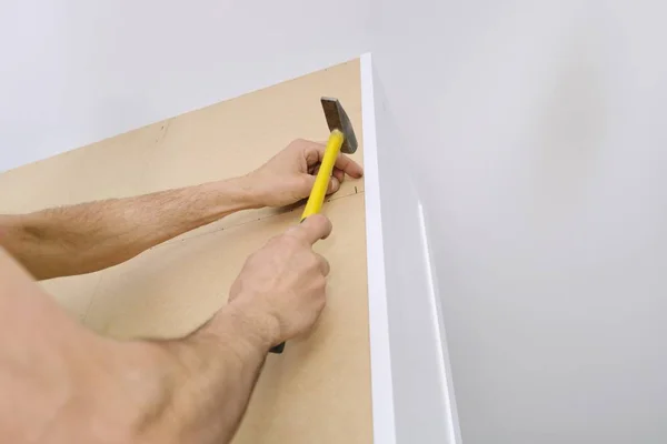 Installation of furniture. Closeup of workers hand with professional tools and furniture details — Stock Photo, Image