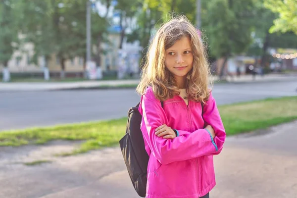 Portrait of school girl in jacket with backpack — Stock Photo, Image
