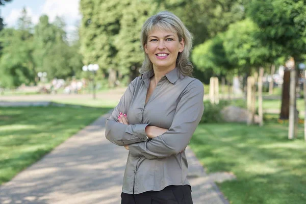 Outdoor portrait of positive mature middle-aged woman — Stock Photo, Image