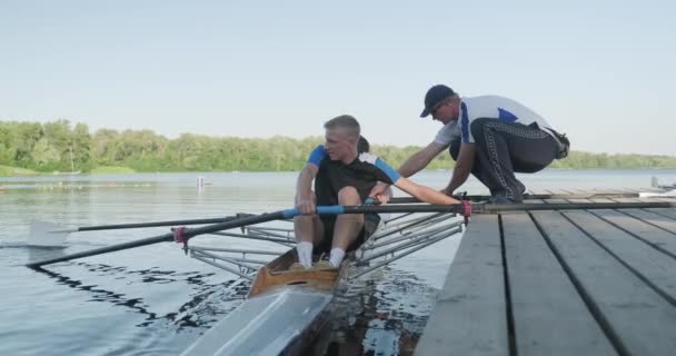 Kiev UA, 31-07-2019. Sport team van tiener jongens geleid door coach in kajak boot op het water — Stockvideo