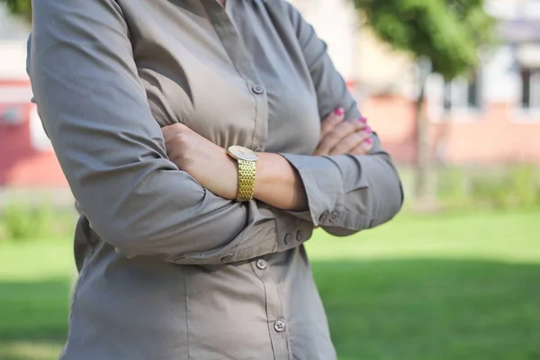 Close up of folded arms of business woman — Stock Photo, Image