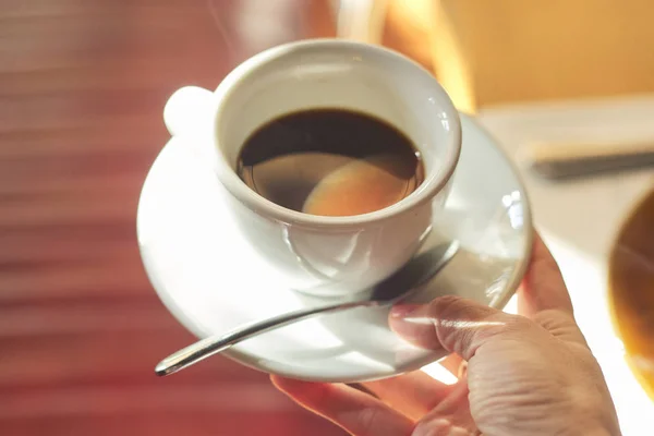 Cup with morning coffee in female hand — Stock Photo, Image