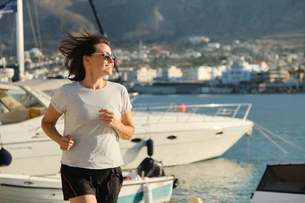 Sportieve volwassen vrouw joggen lopen op de promenade — Stockfoto