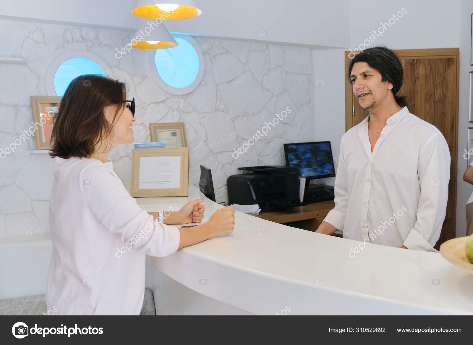 Resort Hotel Front Desk Woman Guest Talking To Man Working At