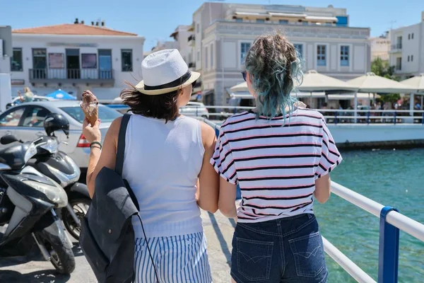 Mediterranean, people women back near sea promenade — стоковое фото