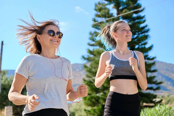 Aktif atletik aile, anne ve genç kız birlikte koşuyorlar. — Stok fotoğraf
