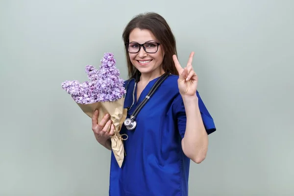 Portrait of female doctor showing you victory sign