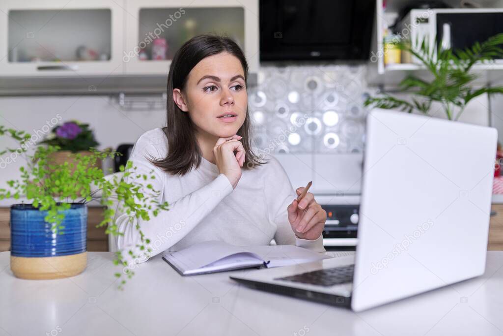 Woman teacher, mentor, psychologist looking at webcam of laptop