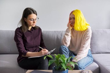 Teen girl giving interview to social worker. School psychologist talking with student clipart