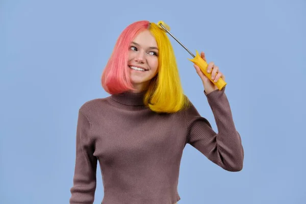 Hermosa chica se tiñe el pelo con rodillo de construcción — Foto de Stock