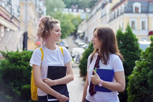 Duas alunas conversando em uma rua da cidade, adolescentes com mochilas — Fotografia de Stock